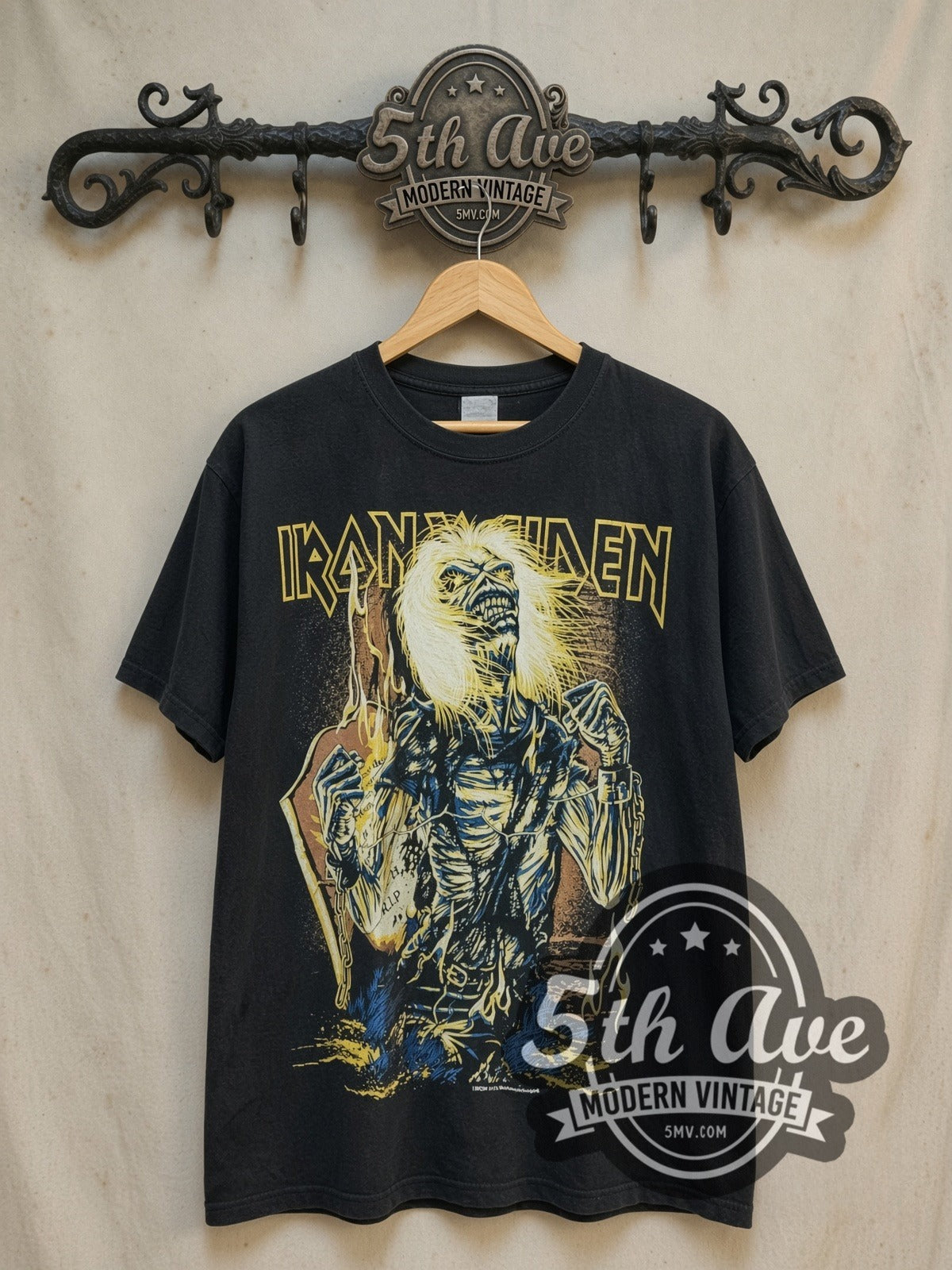 Iron Maiden Chained Eddie RIP Tombstone vintage band t-shirt, front view on a display rack