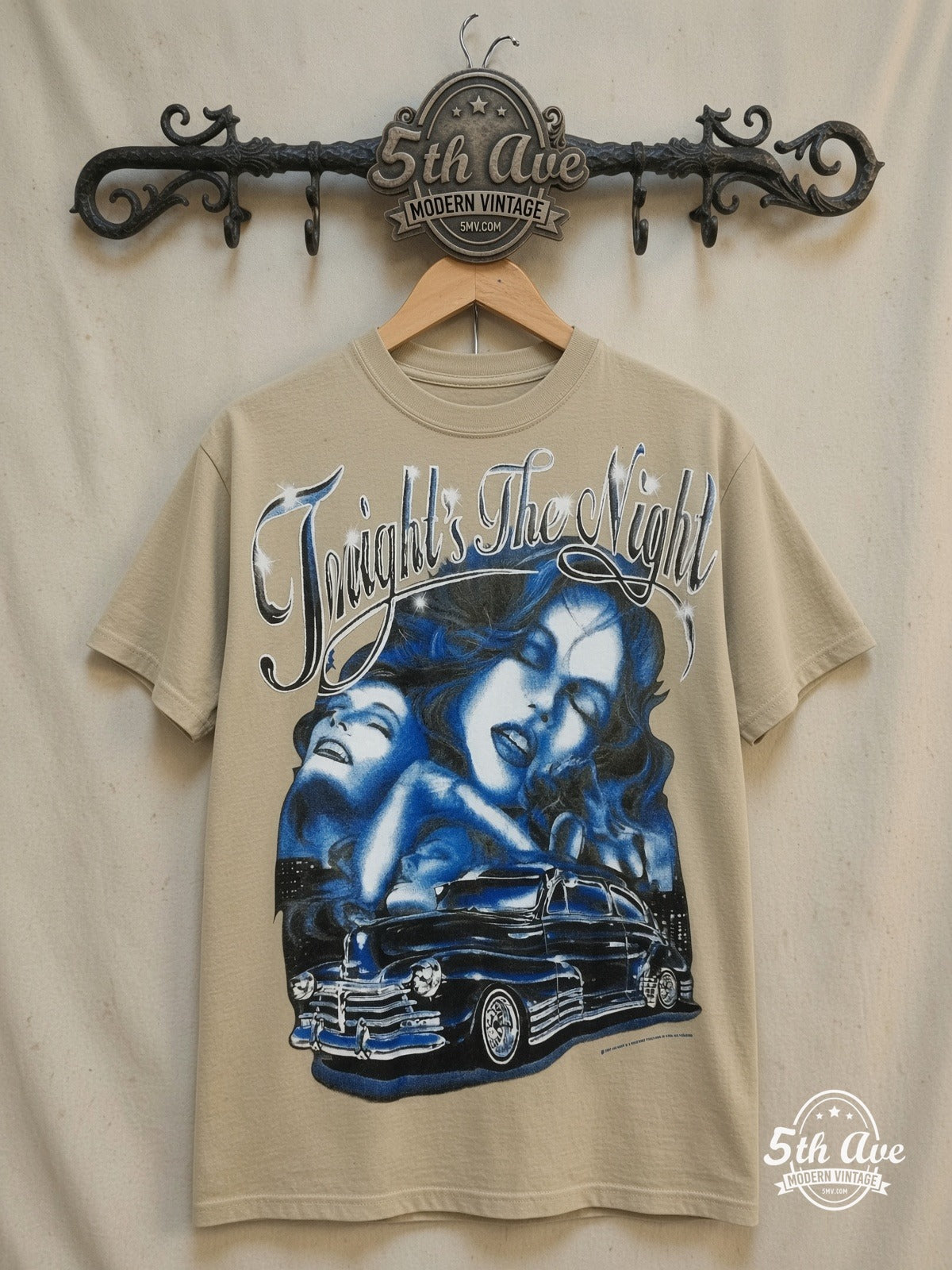 Rollin Hard Tonight's the Night Lowrider graphic tee in sand, front view on a display rack