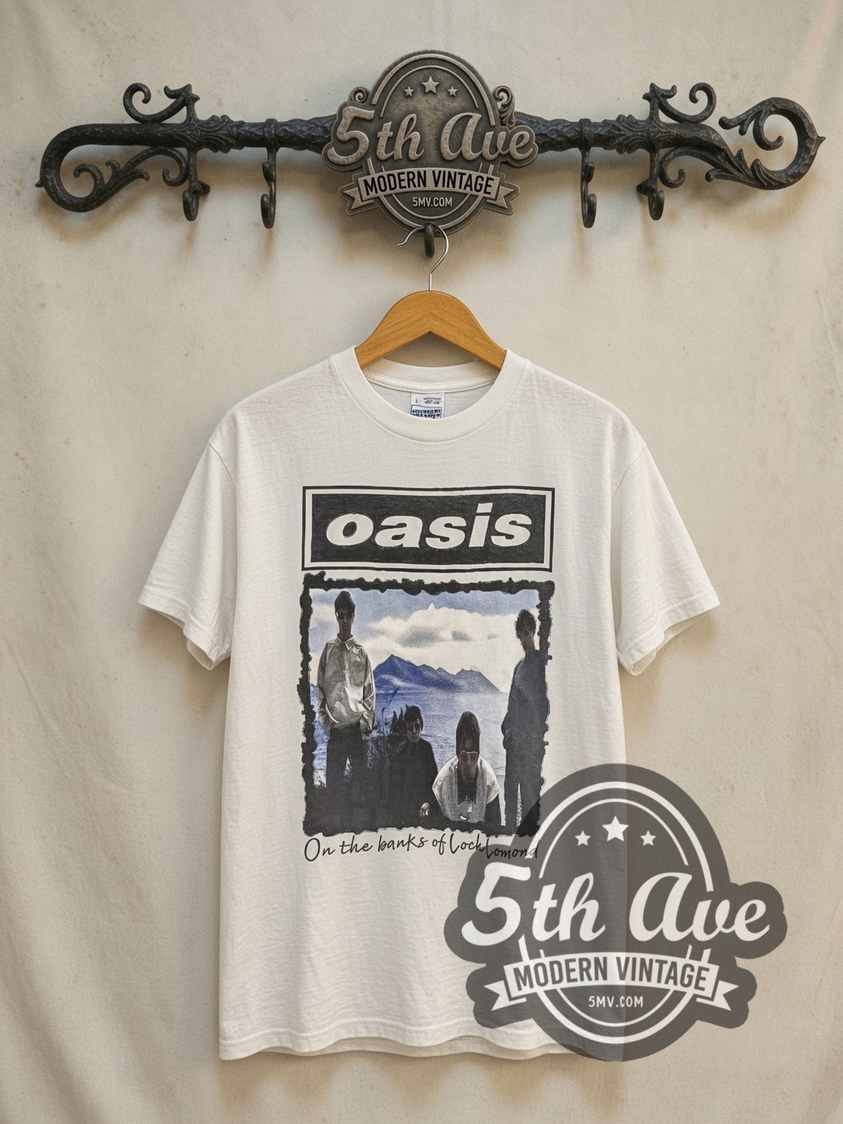 Oasis Morning Glory Tour 1996 vintage band t-shirt in white, front view on a display rack