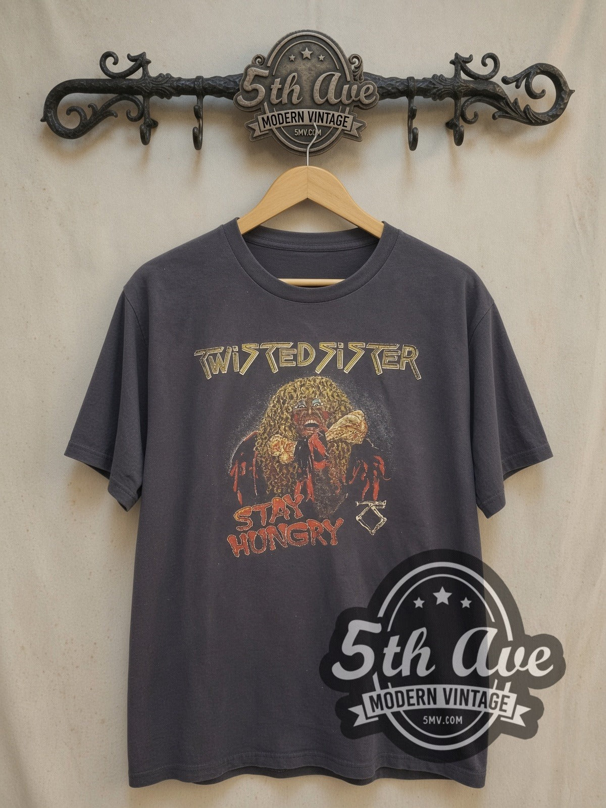 Twisted Sister Stay Hungry Dee Snider Biting Bone vintage band t-shirt, front view on a display rack