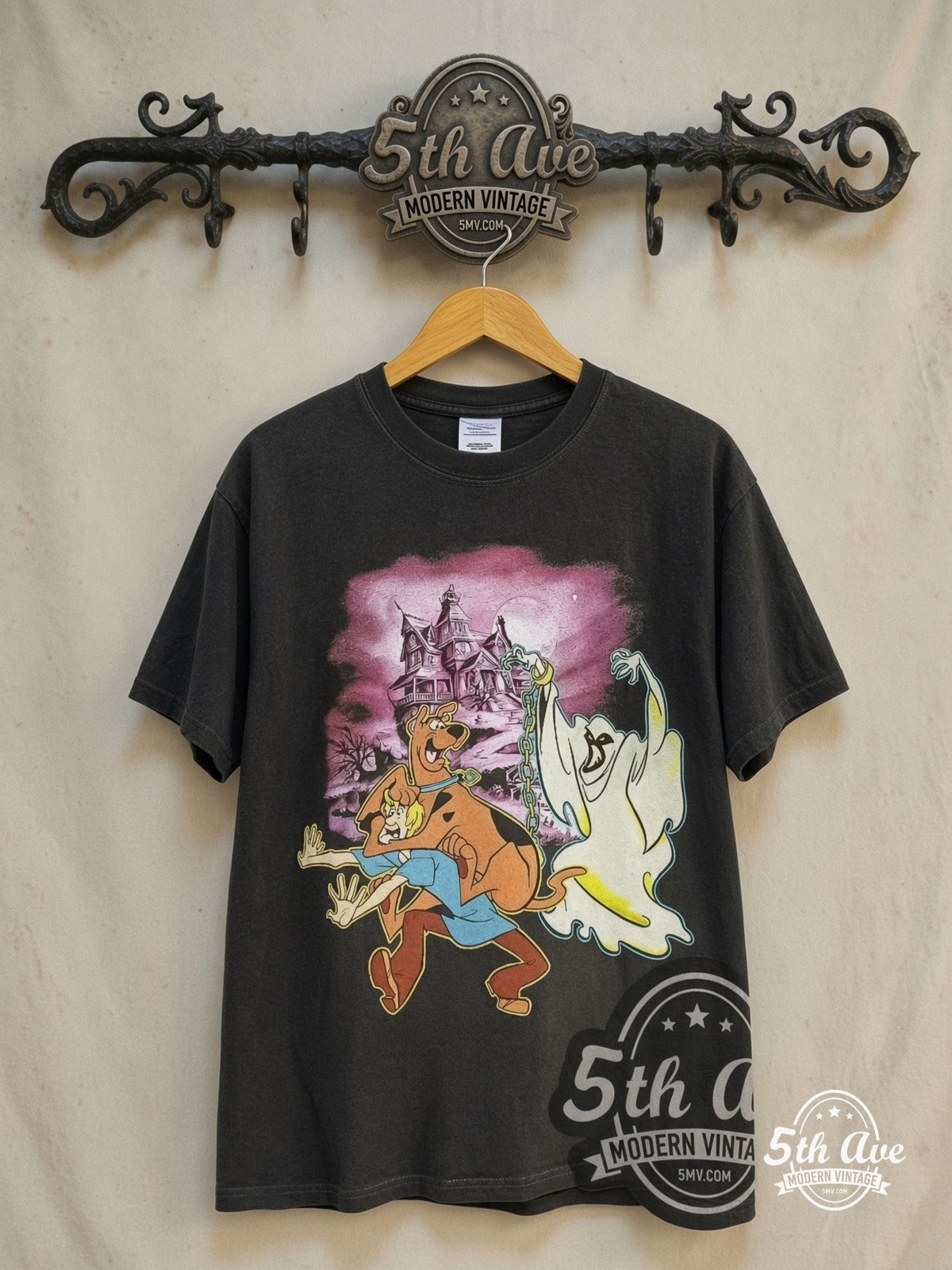Scooby-Doo Haunted Mansion graphic tee in black, front view on a display rack