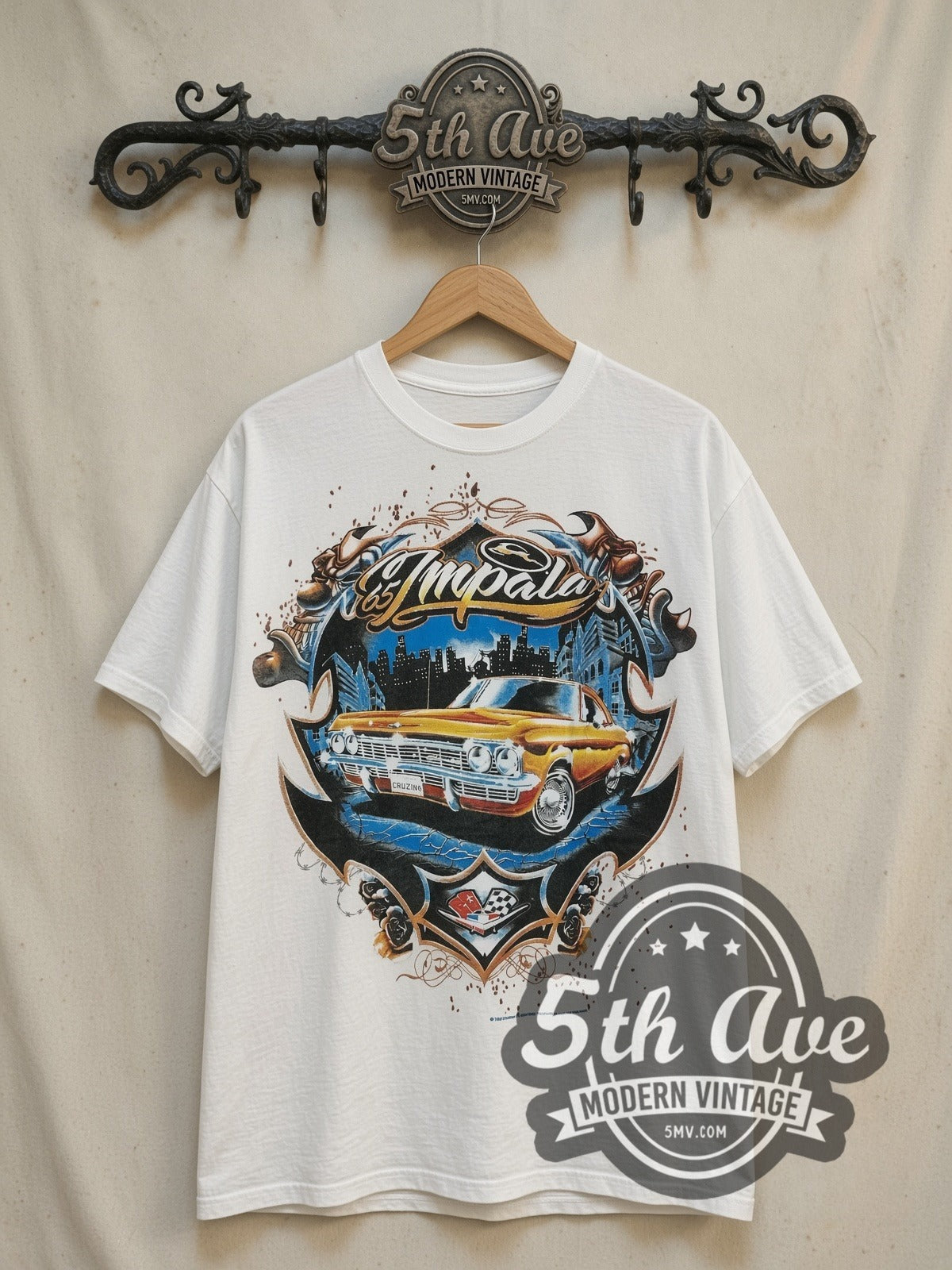 Rollin Hard '65 Impala Lowrider vintage graphic tee, front view on a display rack
