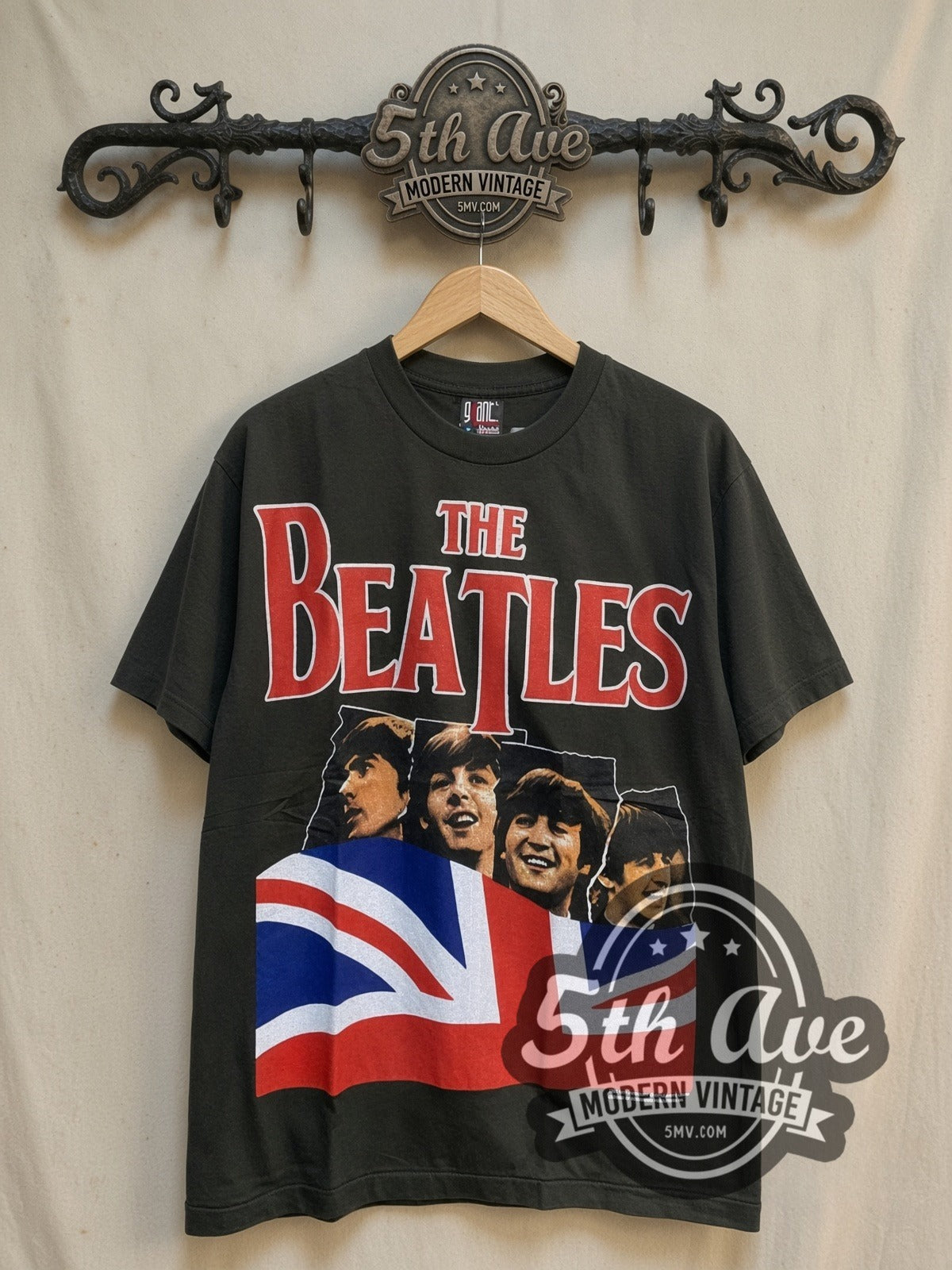 The Beatles Union Jack Red Logo Mop-Top vintage band t-shirt, front view on a display rack