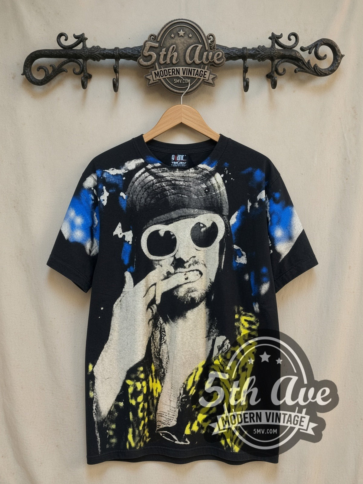 Nirvana Kurt Cobain White Sunglasses Leopard all-over-print vintage band t-shirt in black, front view on a display rack