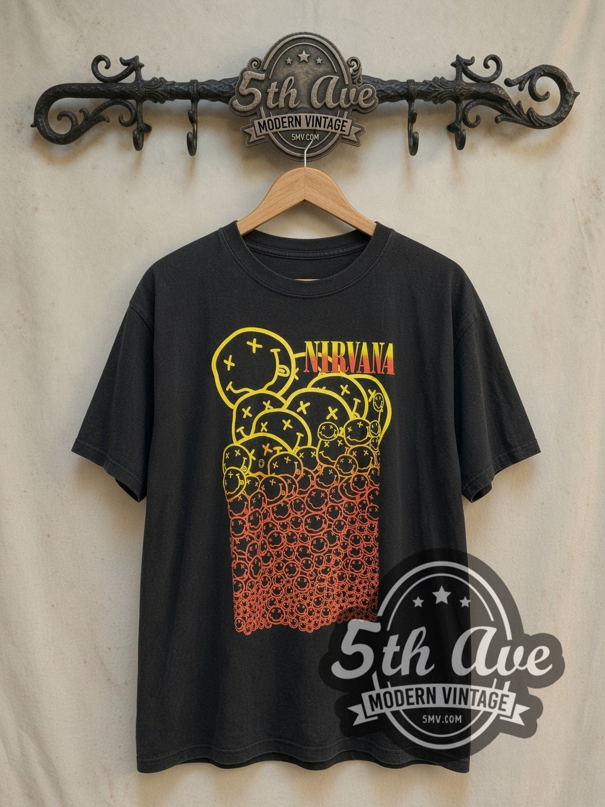Nirvana Stacked Gradient Smileys Yellow to Red vintage band t-shirt, front view on a display rack