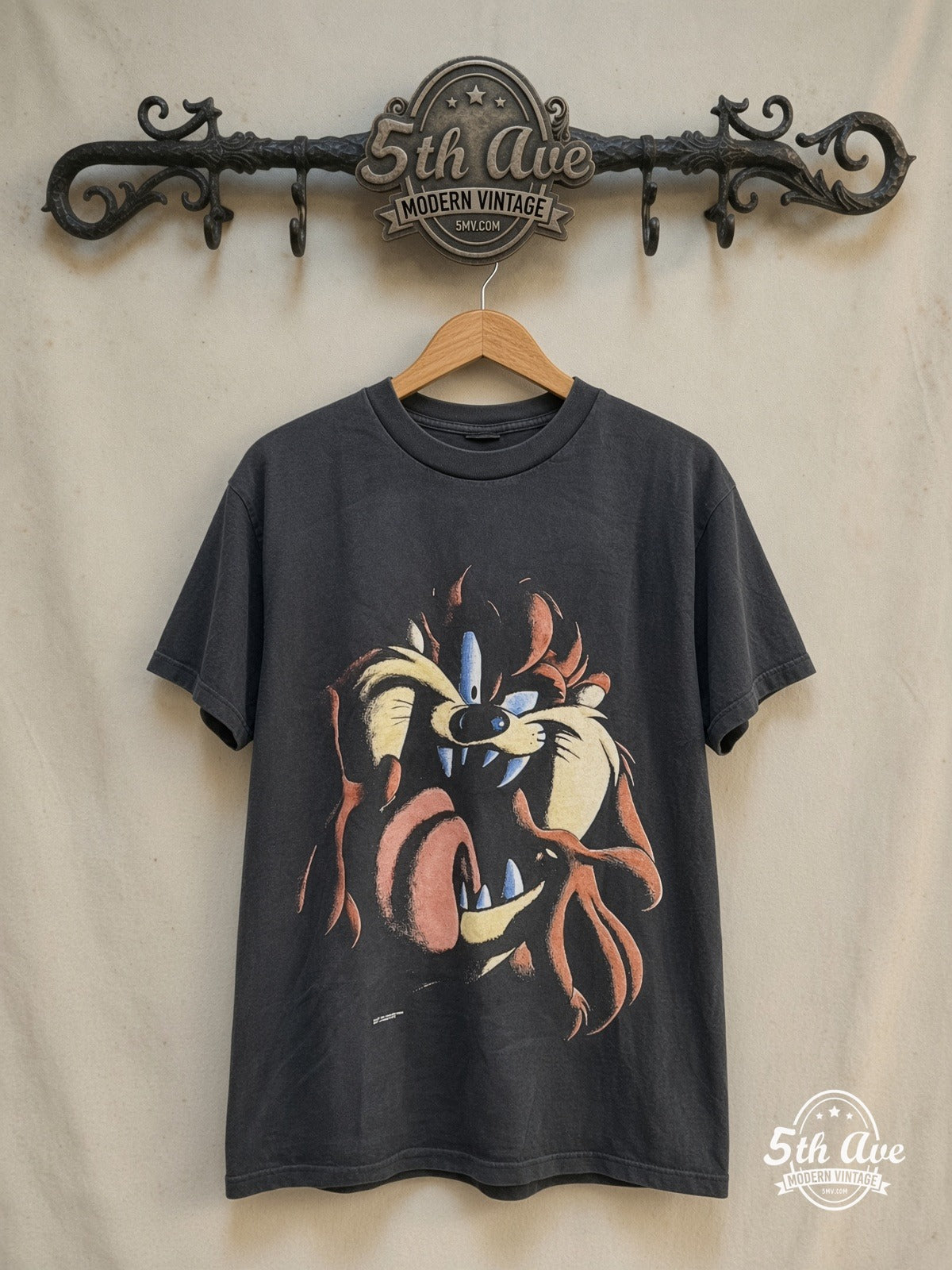 Looney Tunes Taz-Mania vintage cartoon tee in black, front view on a display rack