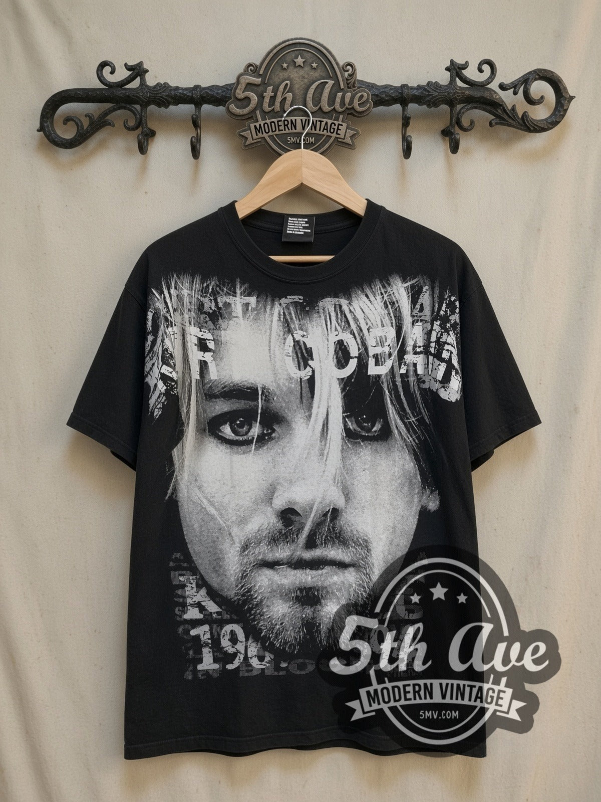 Nirvana Kurt Cobain Face Portrait vintage band t-shirt, front view on a display rack
