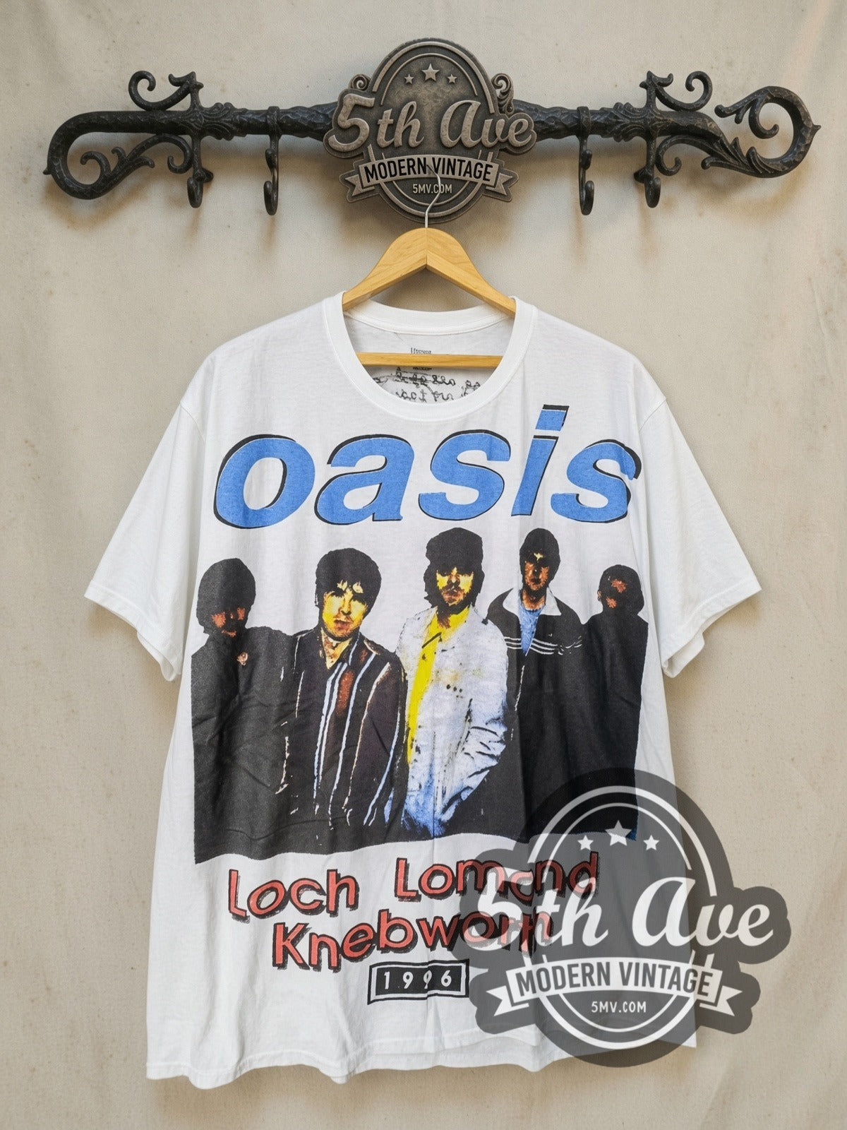 Oasis Loch Lomond and Knebworth vintage band t-shirt, front view on a display rack