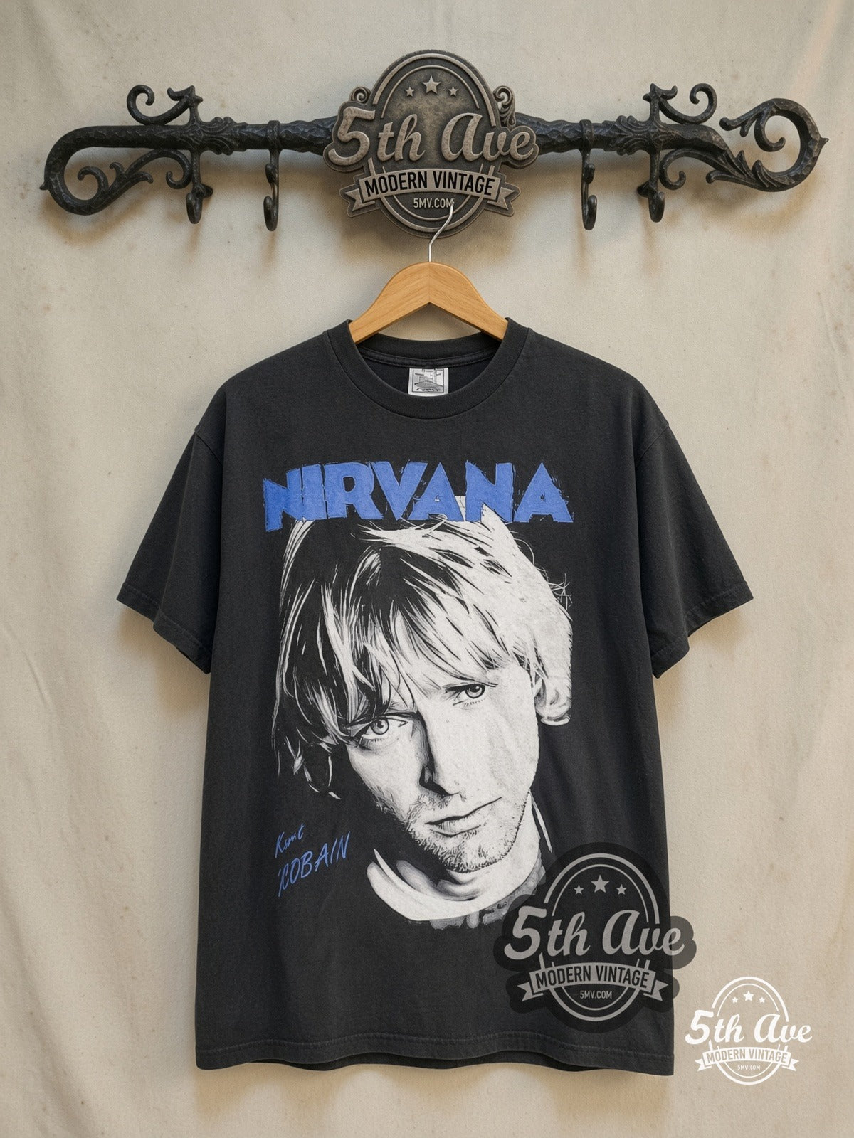 Nirvana – Kurt Cobain Blue Logo Play Electric Guitar – Vintage Band T-Shirt — front on locked cream ornate 5th Ave rack