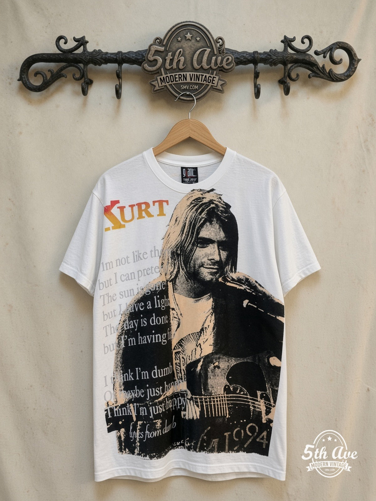 Nirvana – Live at Last – Vintage Band T-Shirt — front on locked cream ornate 5th Ave rack