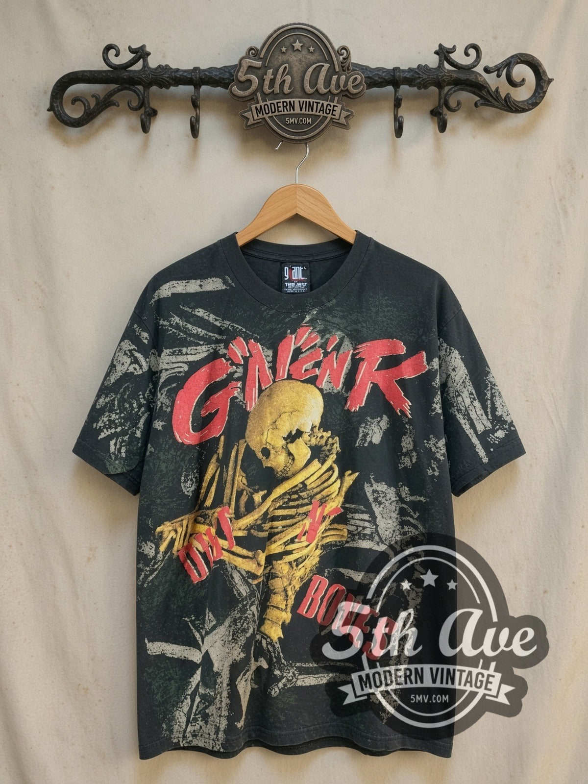 Guns N' Roses Dirt N Bones Skeleton all-over-print vintage band t-shirt, front view on a display rack