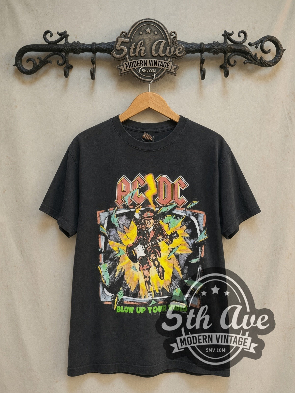 AC/DC Blow Up Your Video TV Burst City List vintage band t-shirt in black, front view on a display rack