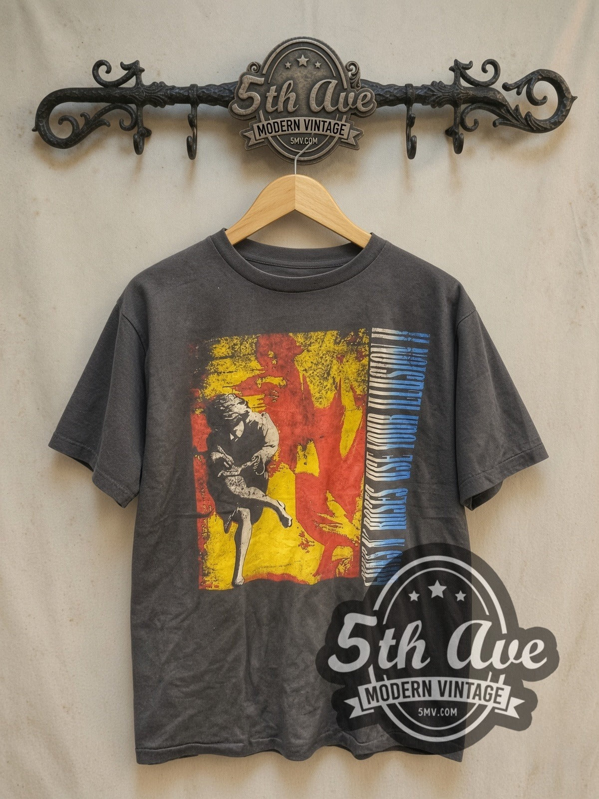 Guns N' Roses Use Your Illusion vintage band t-shirt, front view on a display rack
