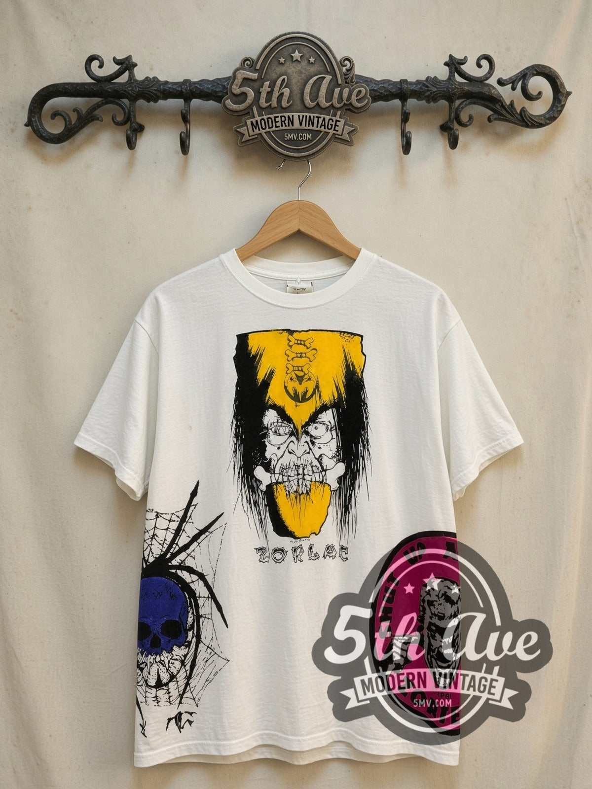 Zorlac Skateboards Shut Up and Skate all-over-print vintage graphic tee, front view on a display rack
