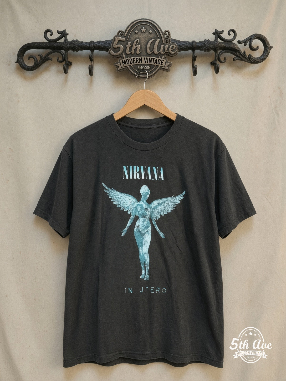 Nirvana – In Utero Weathered Teal Angel – Vintage Band T-Shirt — front on locked cream ornate 5th Ave rack