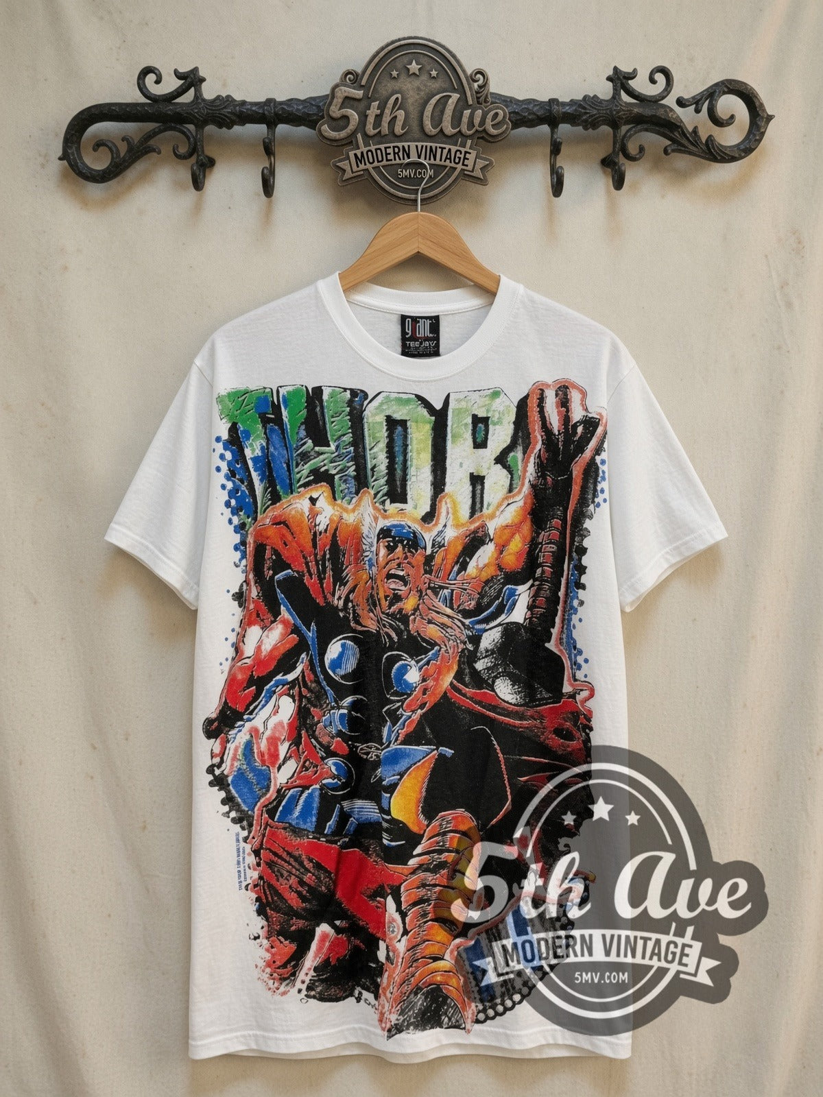 Marvel Thor Odinson Mjolnir Comic all-over-print vintage comic tee in white, front view on a display rack