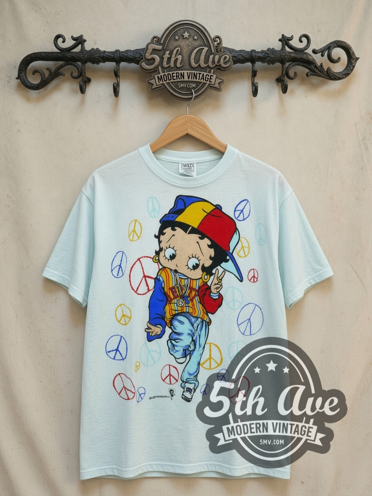Betty Boop Peace all-over-print vintage cartoon t-shirt, front view on a display rack