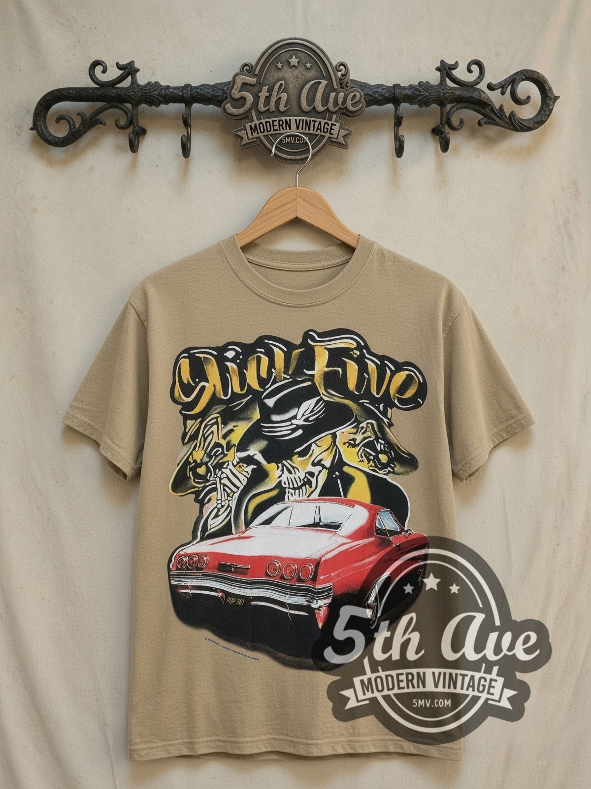 Rollin Hard Slick Five Lowrider vintage graphic tee in sand, front view on a display rack