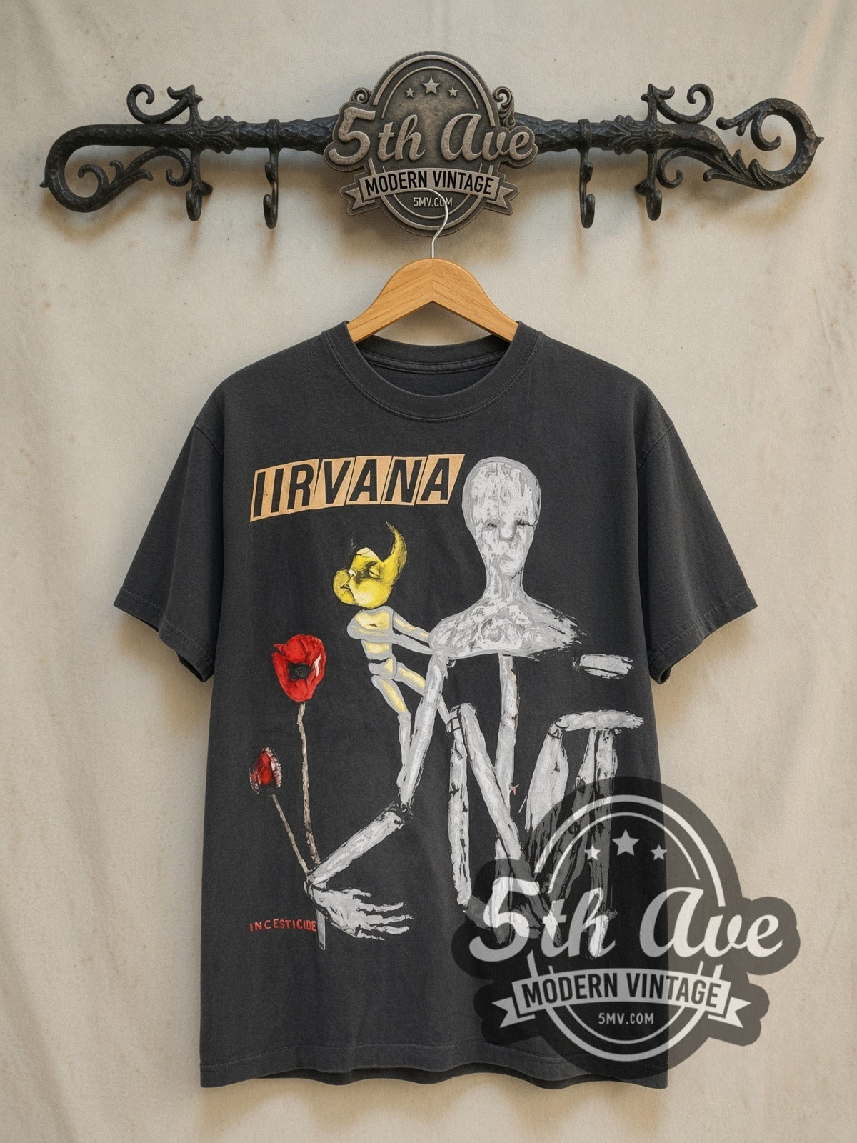 Nirvana Incesticide vintage band t-shirt in black, front view on a display rack