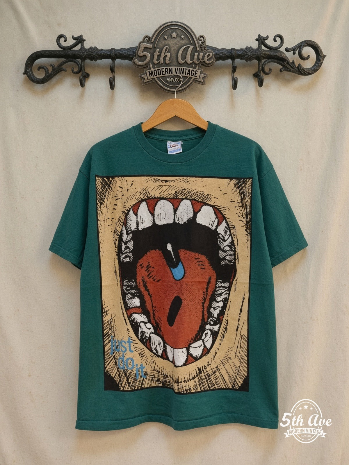 Akira Just Do It all-over-print anime tee, front view on a display rack