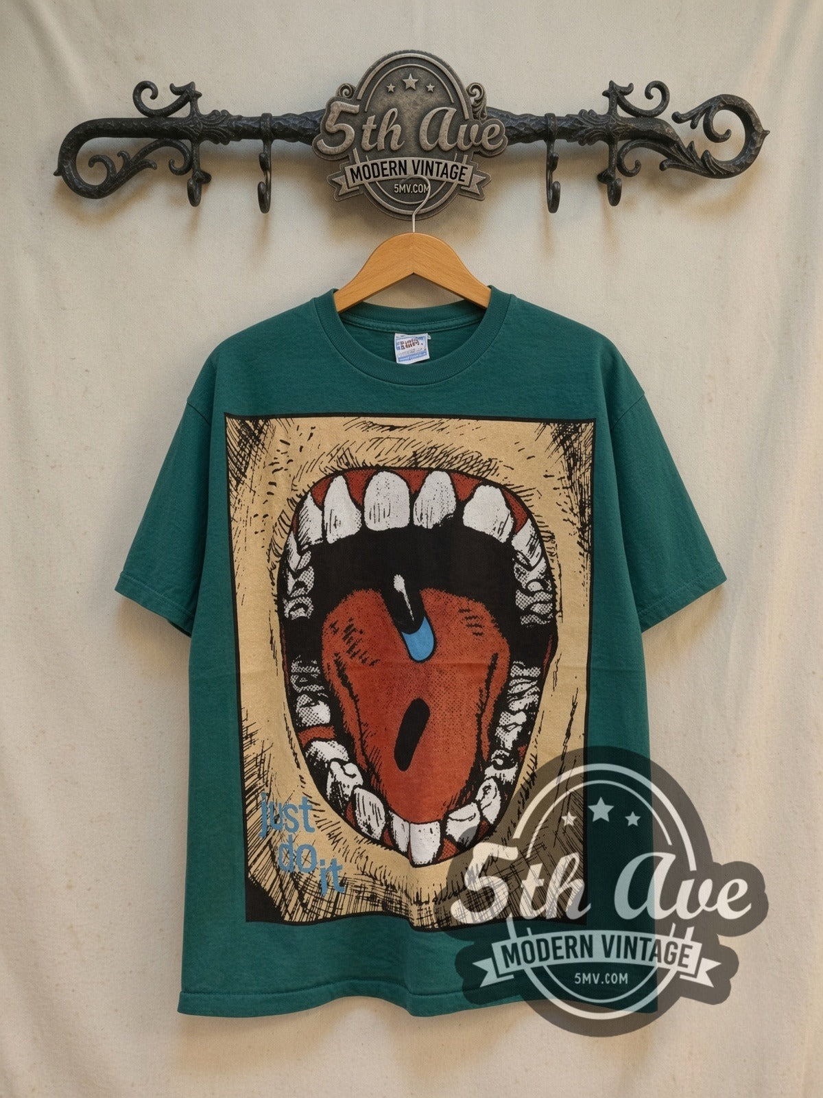 Akira Just Do It all-over-print vintage graphic t-shirt, front view on a display rack