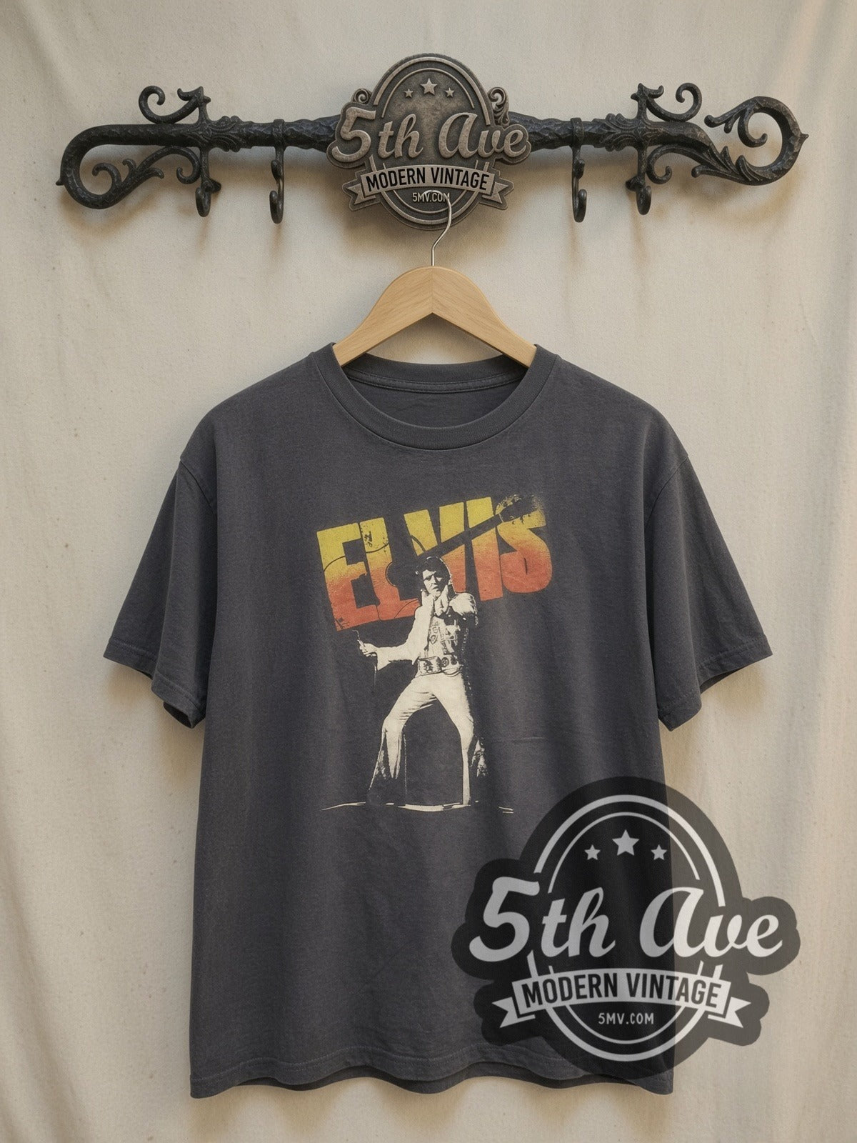 Elvis Presley Stage Pose Logo vintage band t-shirt, front view on a display rack