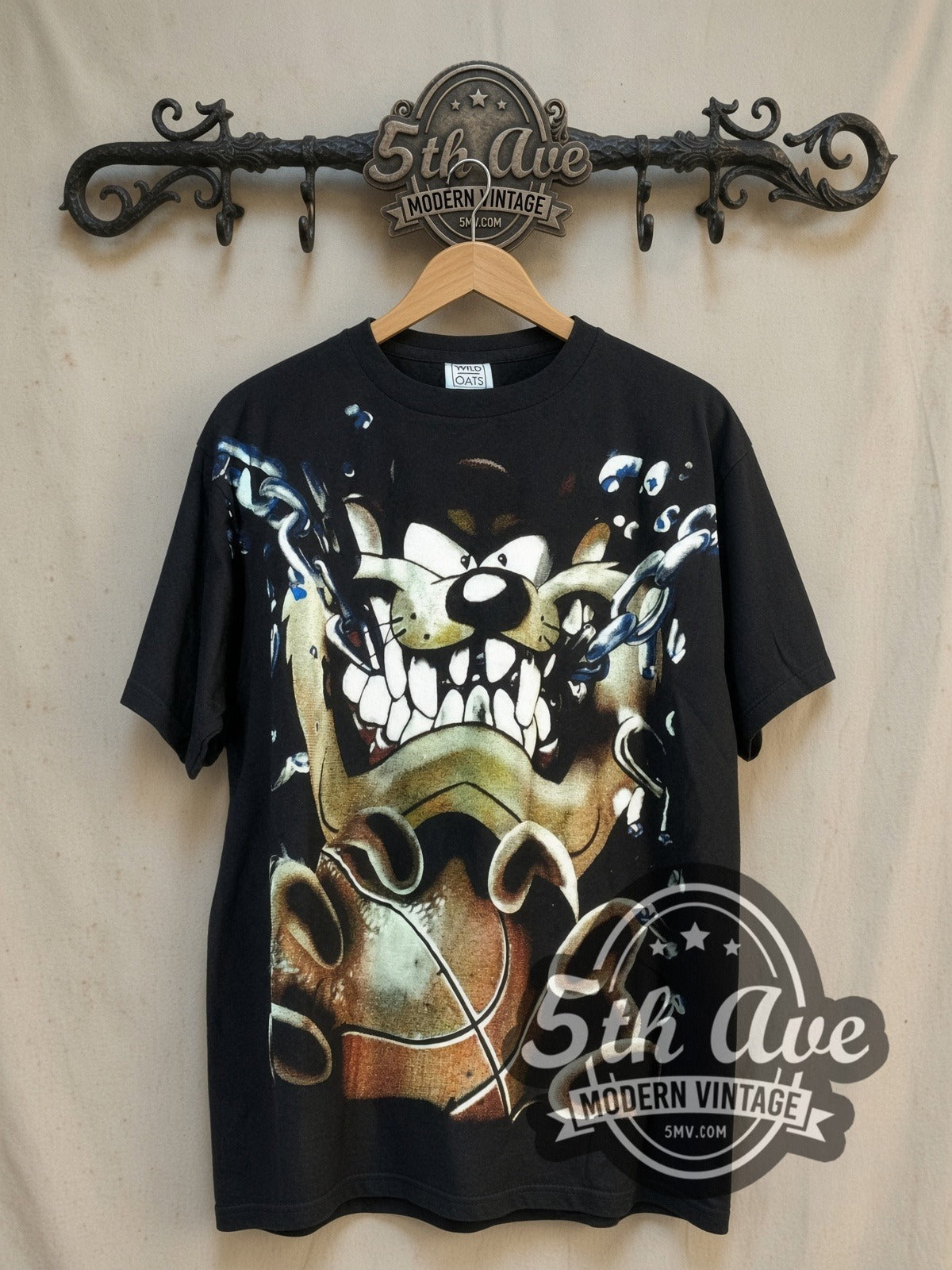 Looney Tunes Taz-Mania Taz Tunes all-over-print vintage cartoon tee, front view on a display rack