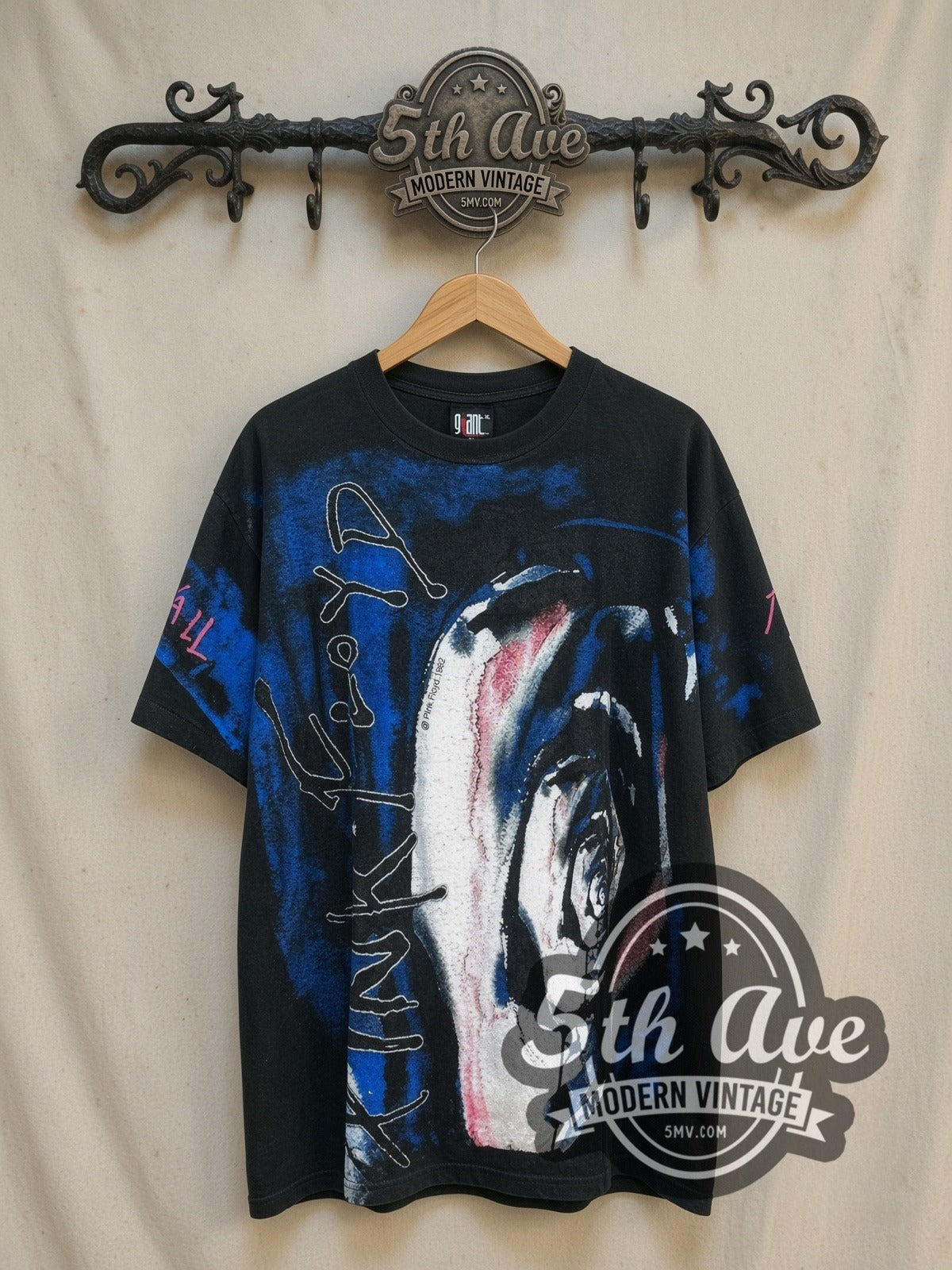 Pink Floyd The Wall all-over-print vintage band t-shirt, front view on a display rack