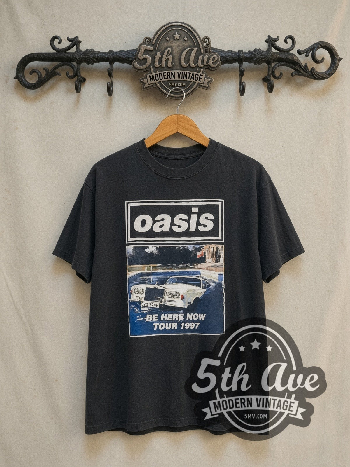 Oasis Be Here Now' Tour 1997 vintage band t-shirt in black, front view on a display rack