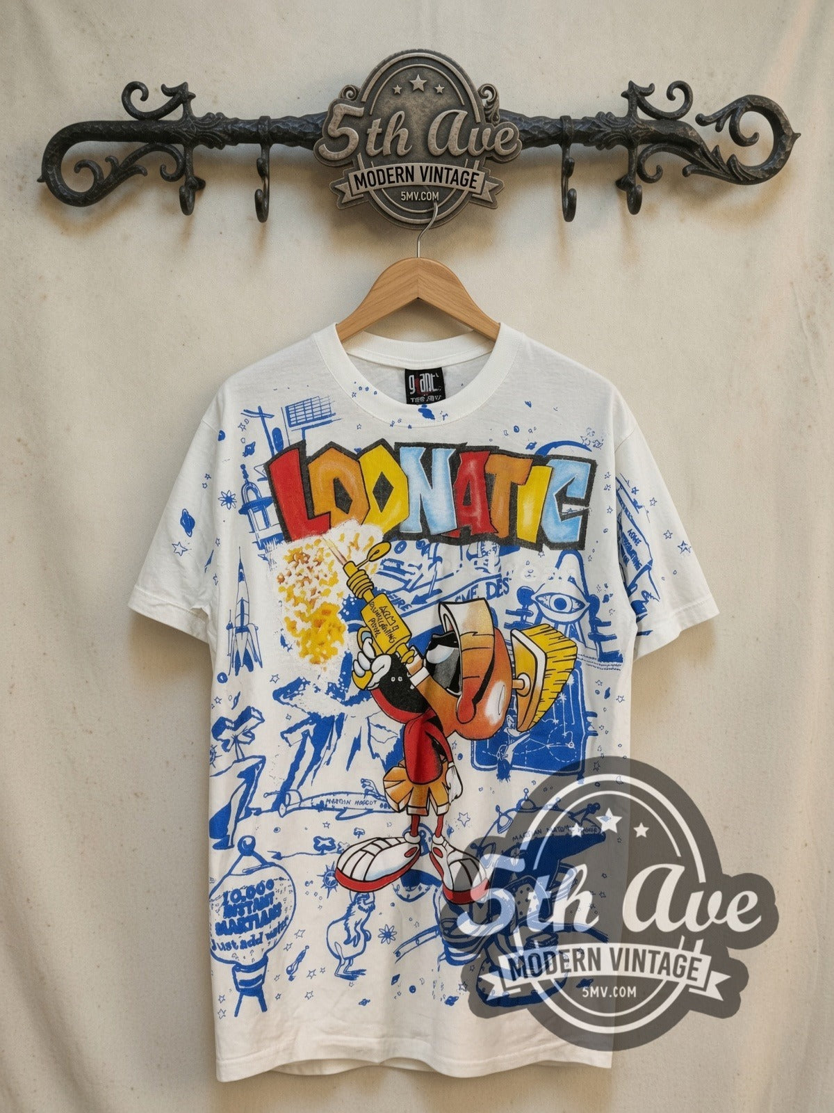 Looney Tunes Marvin the Martian Loonatic Streetwear all-over-print vintage cartoon tee, front view on a display rack