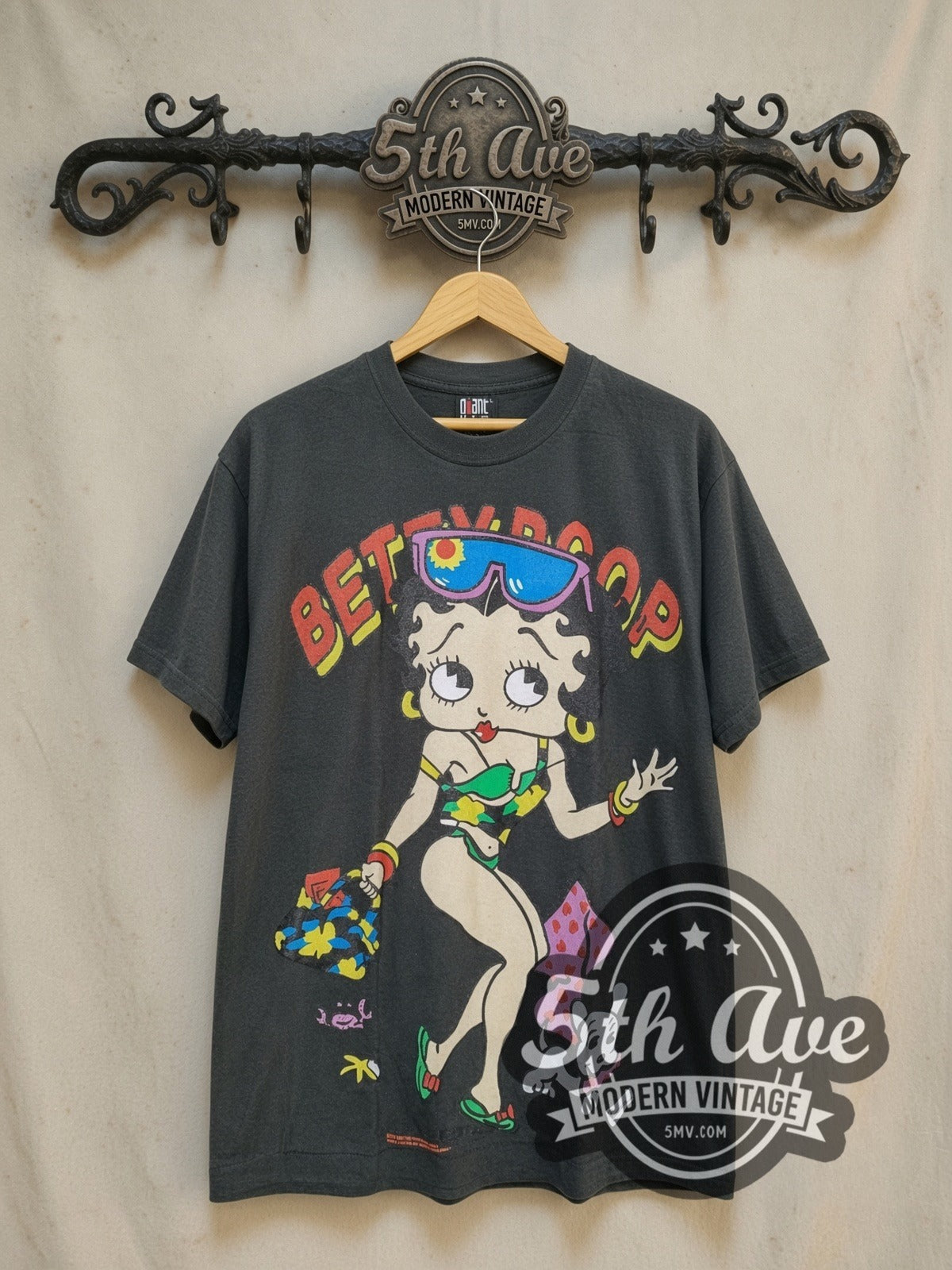 Betty Boop Beach Vibes vintage cartoon t-shirt Vintage Glamour graphic tee, front view on a display rack