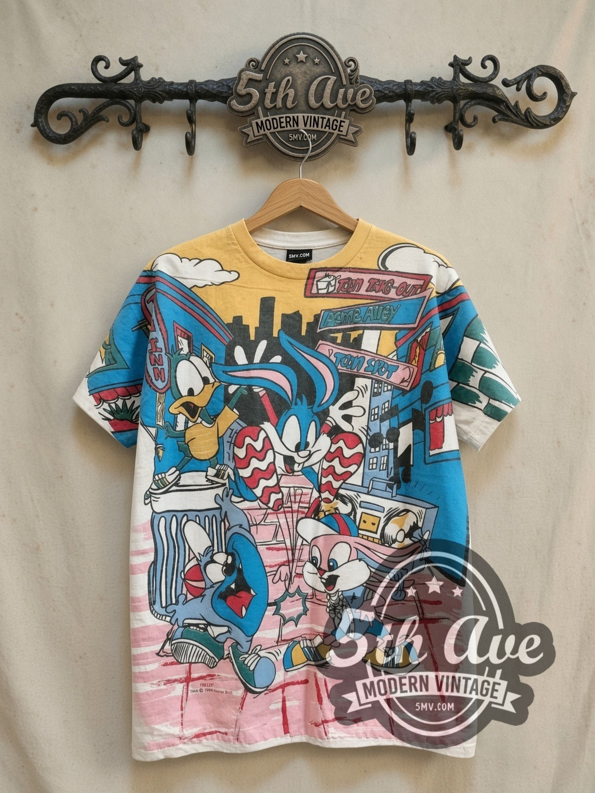 Looney Tunes all-over-print vintage cartoon tee, front view on a display rack