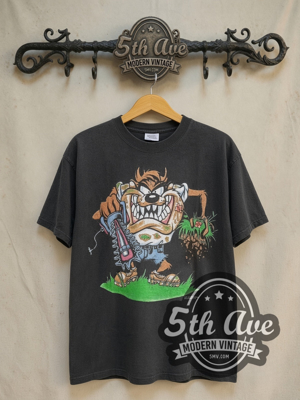 Looney Tunes Taz-Mania Landscaping vintage cartoon tee in black, front view on a display rack