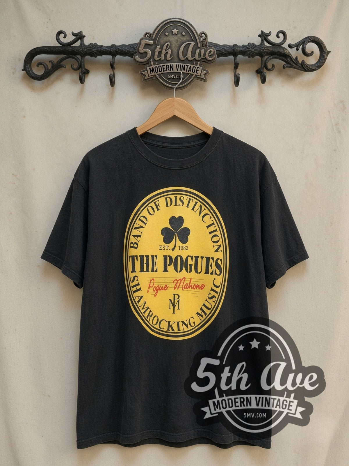 The Pogues Pogue Mahone vintage band t-shirt, front view on a display rack