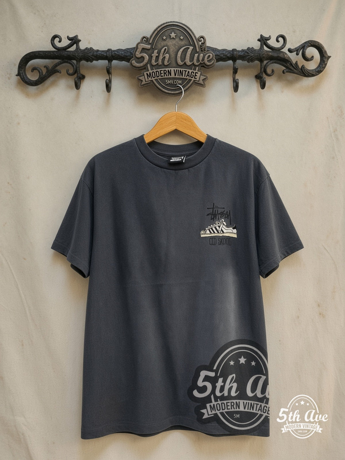 Stussy – Old Skool Flavor – Vintage Graphic Tee — front on locked cream ornate 5th Ave rack