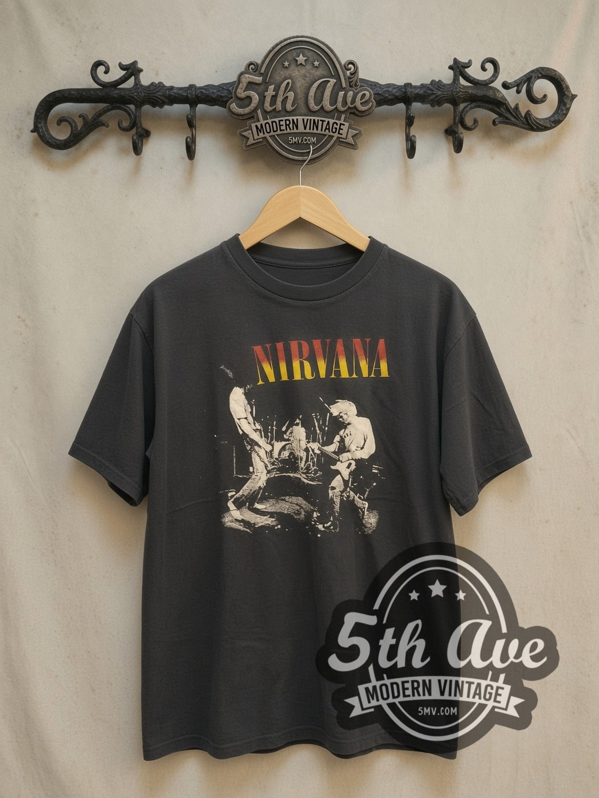 Nirvana Live Stage Photo Red-Yellow Logo vintage band t-shirt, front view on a display rack