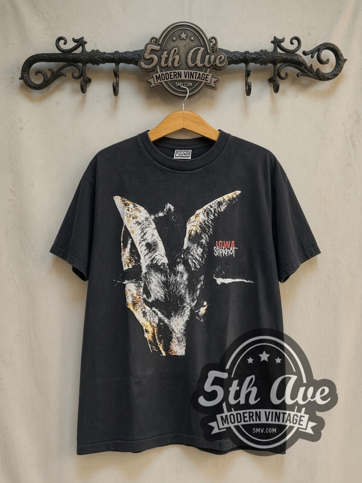 Slipknot Iowa vintage band t-shirt in black, front view on a display rack