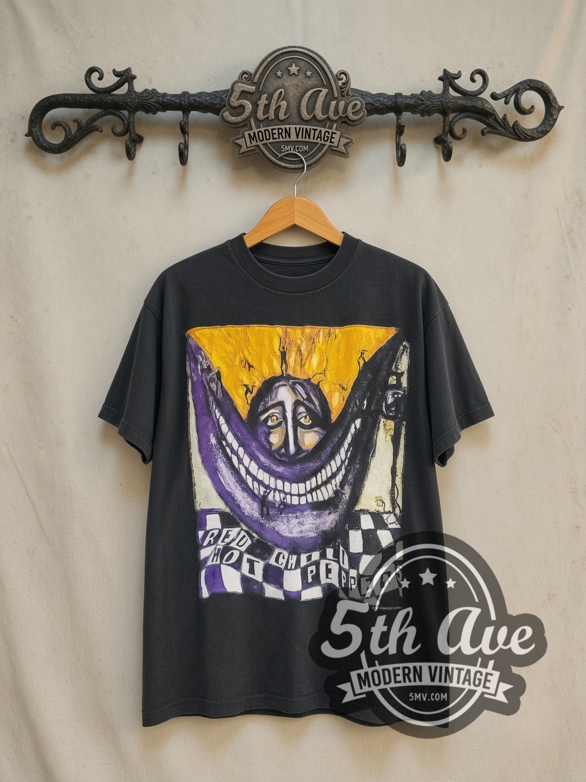 Red Hot Chili Peppers Warlocks Big Smile Checkered vintage band t-shirt in black, front view on a display rack