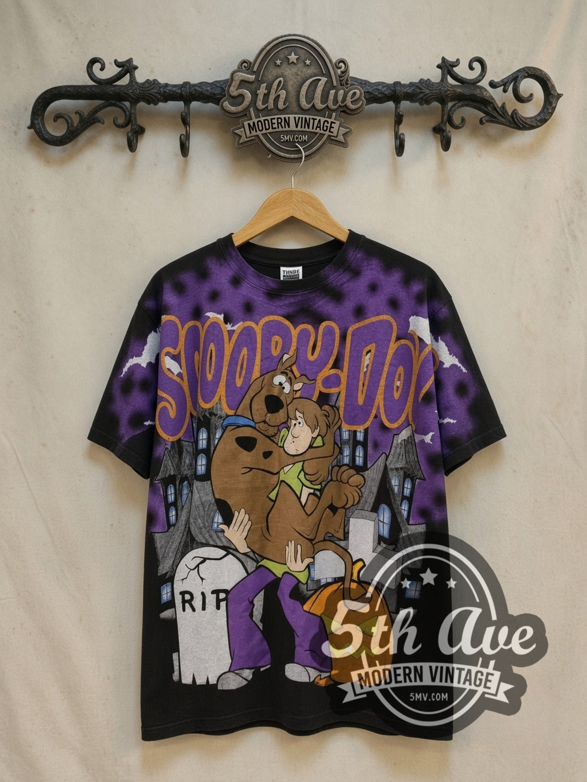 Scooby-Doo Graveyard Halloween all-over-print vintage cartoon tee, front view on a display rack