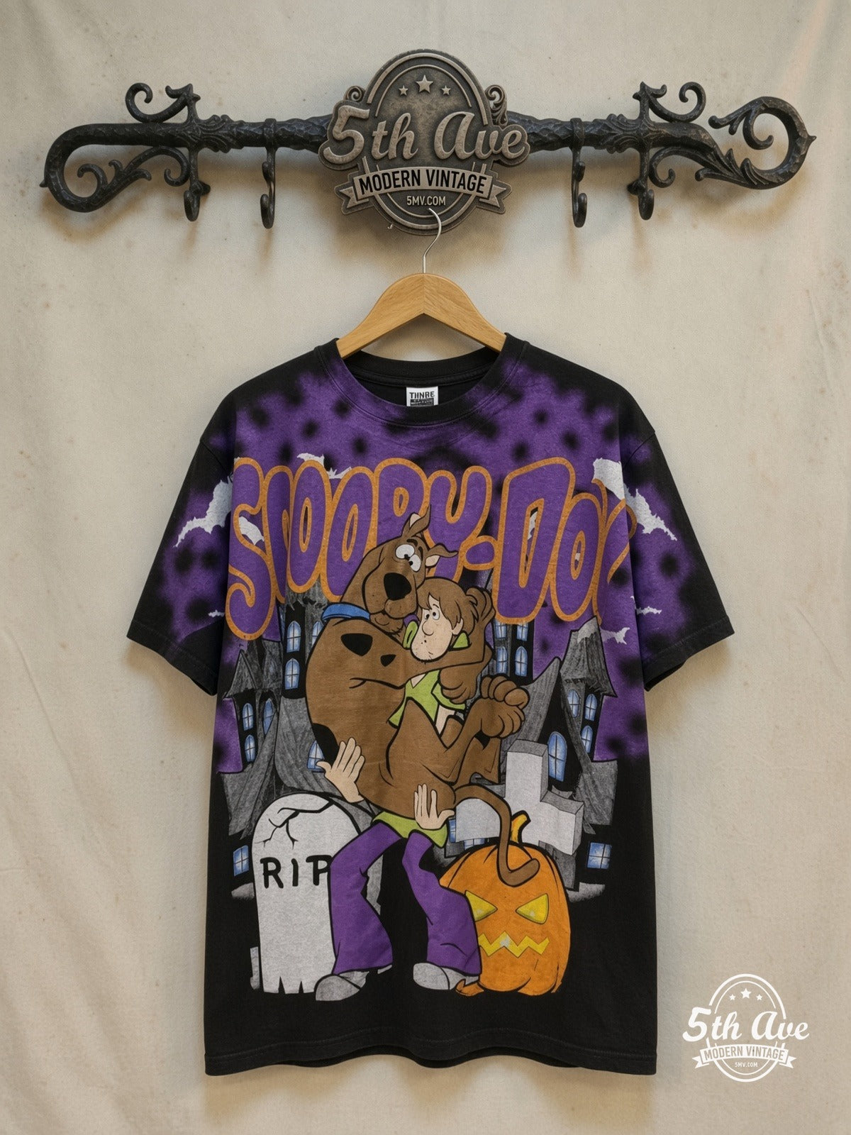 Scooby-Doo Action-Packed T-Shirt: Embrace Mystery and Adventure – New Vintage Graphic Tee — front on locked cream ornate 5th Ave rack