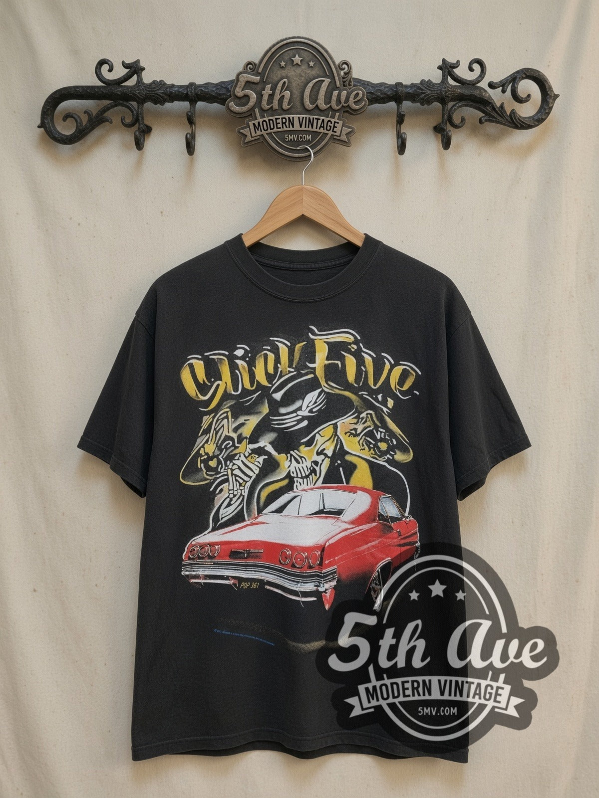 Rollin Hard Slick Five Lowrider vintage graphic tee, front view on a display rack