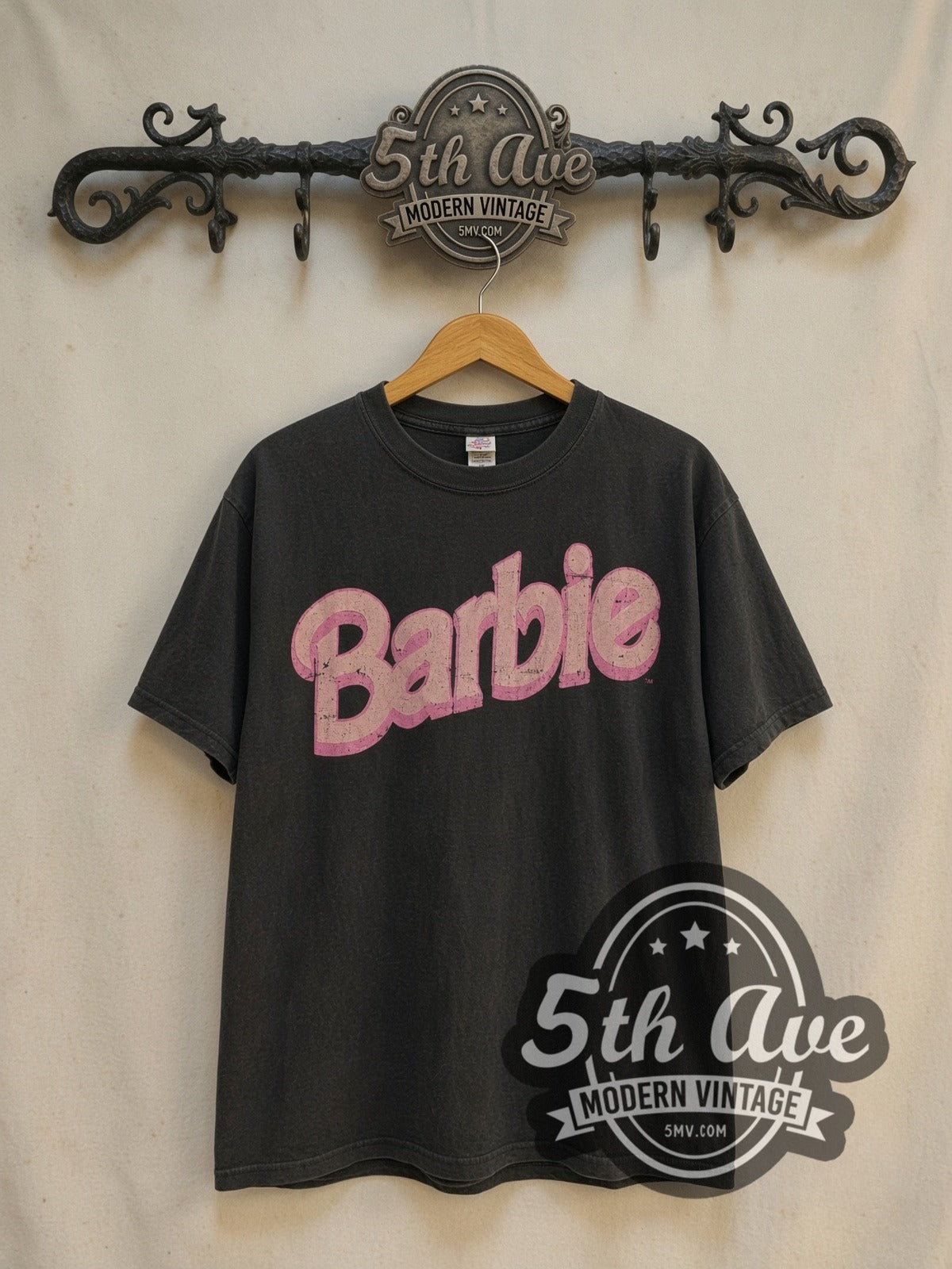 Barbie Pink Heart vintage cartoon tee in black, front view on a display rack