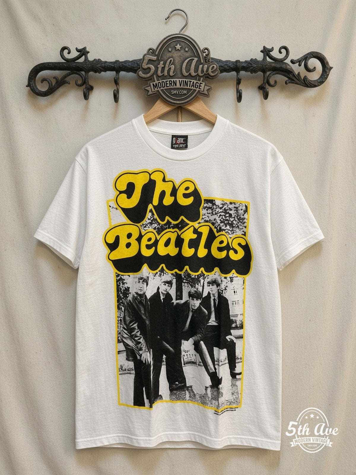 The Beatles – Yellow Bubble Font Early Photo – Vintage Band T-Shirt — front on locked cream ornate 5th Ave rack