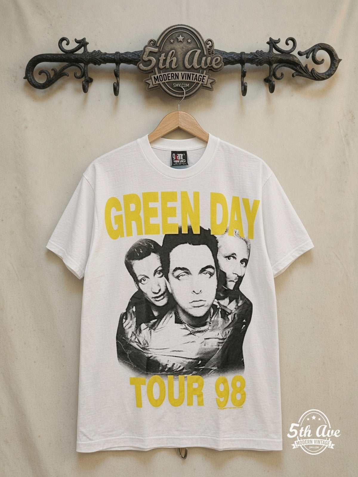 Green Day – Nimrod Tour T-Shirt Vintage Rock Graphic – Vintage Band T-Shirt — front on locked cream ornate 5th Ave rack