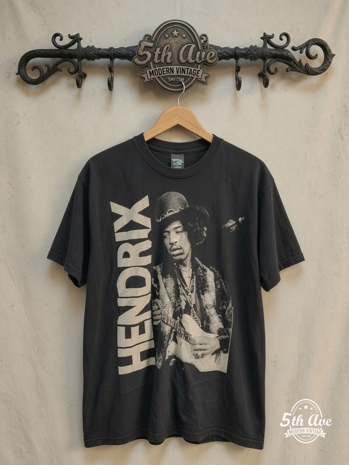 Jimi Hendrix – Hat Guitar Portrait Vertical Name – Vintage Band T-Shirt — front on locked cream ornate 5th Ave rack
