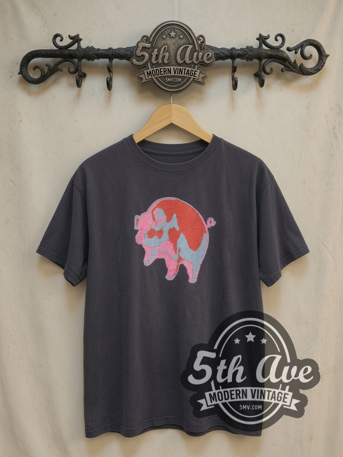 Pink Floyd Animals Red Pink Blue Pig vintage band t-shirt, front view on a display rack
