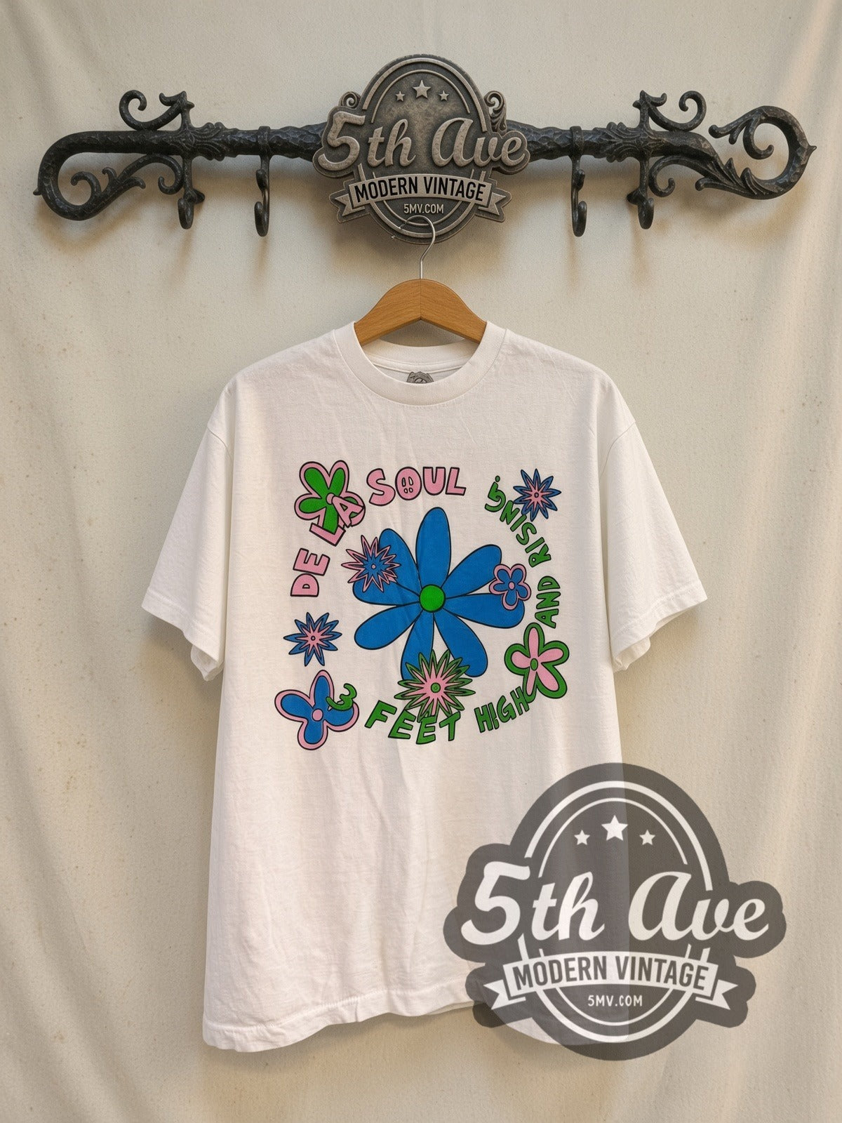 De La Soul 3 Feet High and Rising vintage rap tee in white, front view on a display rack
