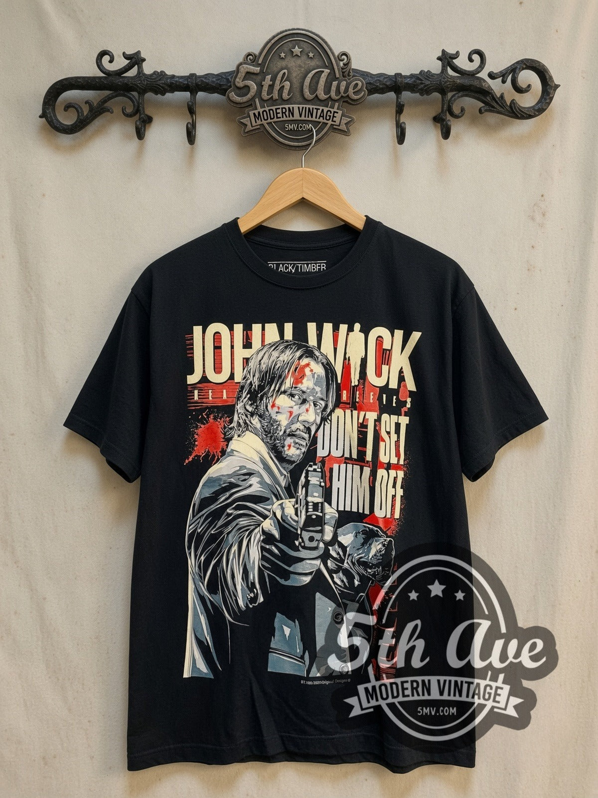 John Wick vintage graphic t-shirt, front view on a display rack