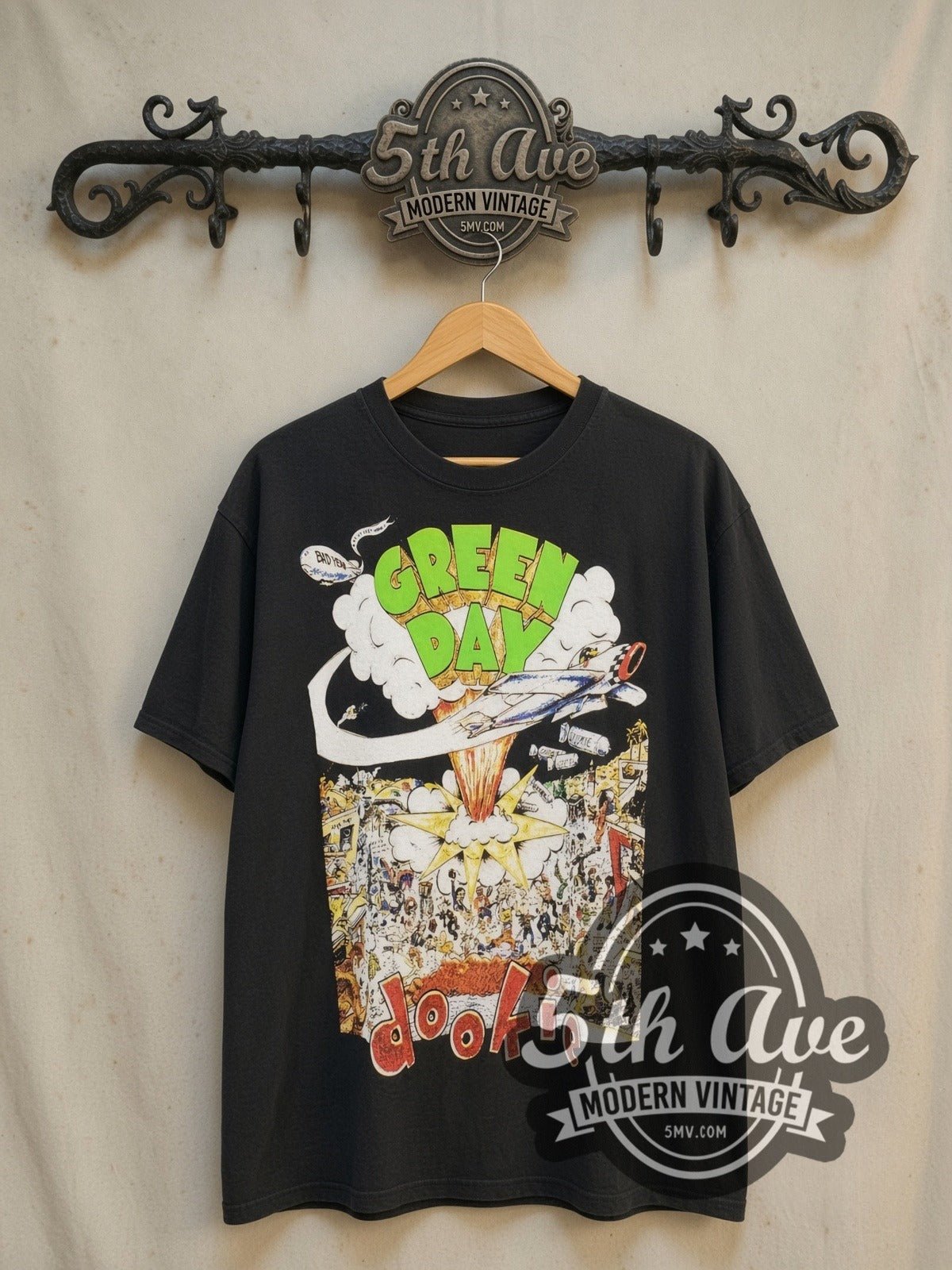 Green Day Dookie Album Cover Bomber vintage band t-shirt, front view on a display rack