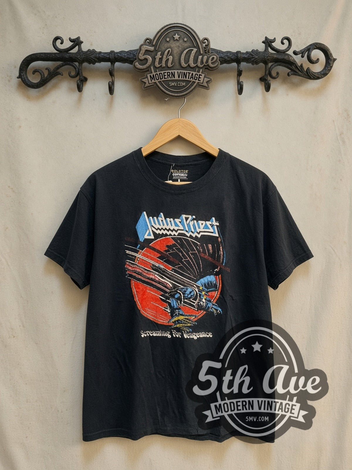 Judas Priest World Tour 1982-83 vintage band t-shirt, front view on a display rack